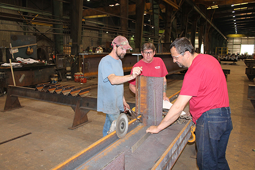 Employees fabricating steel